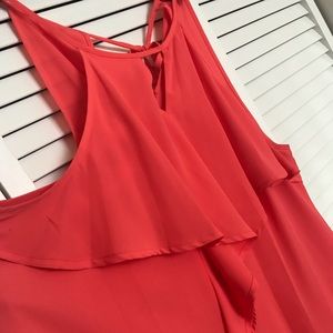 Coral blouse with ruffle details and keyhole